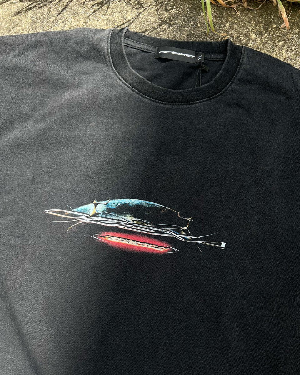 Washed black vintage tee with chrome spaceship and red ODEXA logo, flat lay