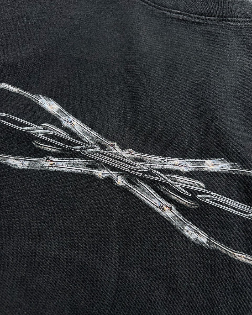 Close-up of chrome Tech logo print on black vintage tee