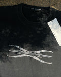 Washed black vintage tee with chrome Tech logo print, sunlit flat lay
