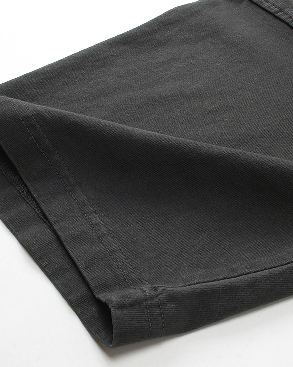 Close-up of folded sleeve cuff on washed black vintage tee showing fabric texture