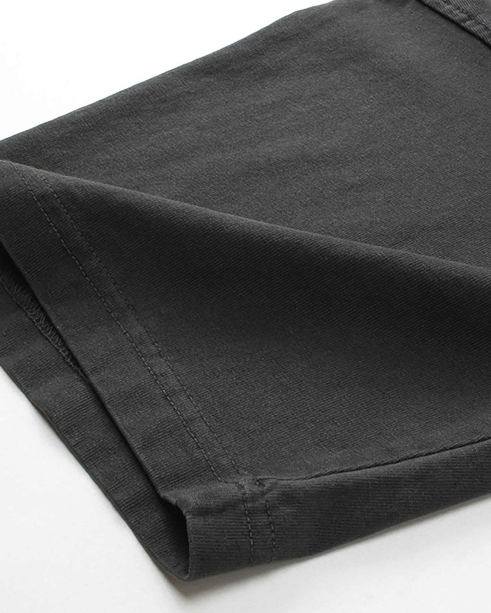 Close-up of folded sleeve cuff on washed black vintage tee showing fabric texture