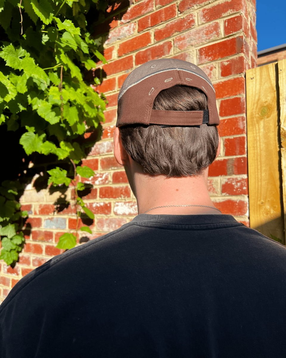 Back of brown Wheat Gold Star contrast cap being worn