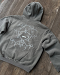 Moss grey boxy hoodie with white tribal bone back print, flat lay