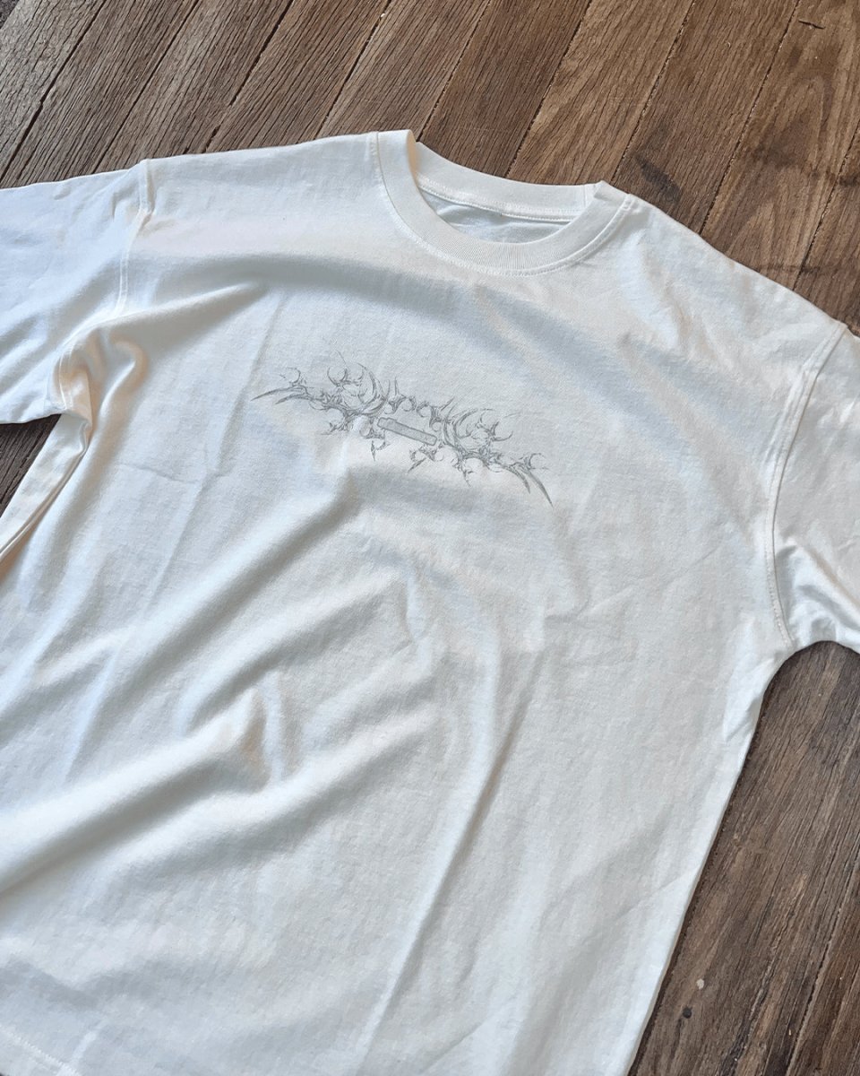 White Bone vintage tee with small tribal chest print, flat lay