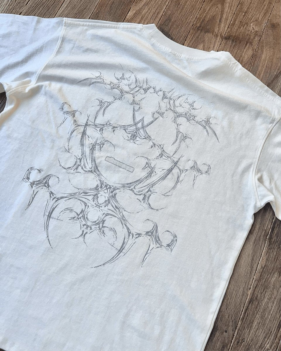 White vintage tee with grey tribal bone line art print, flat lay