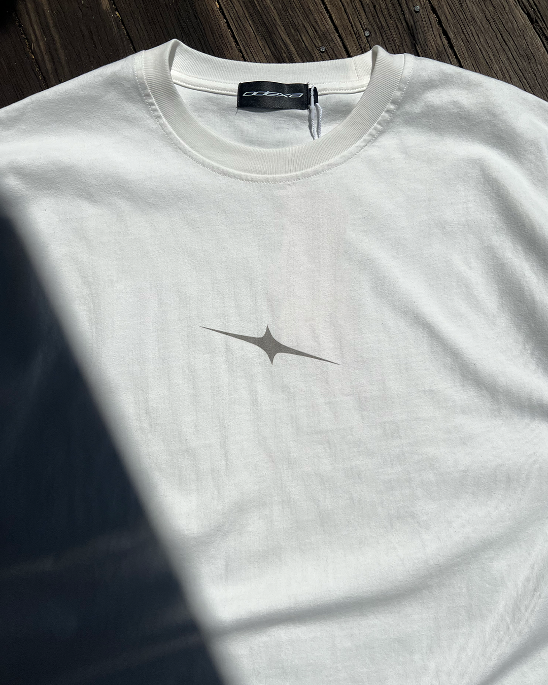 White vintage tee with small grey star chest print, front view