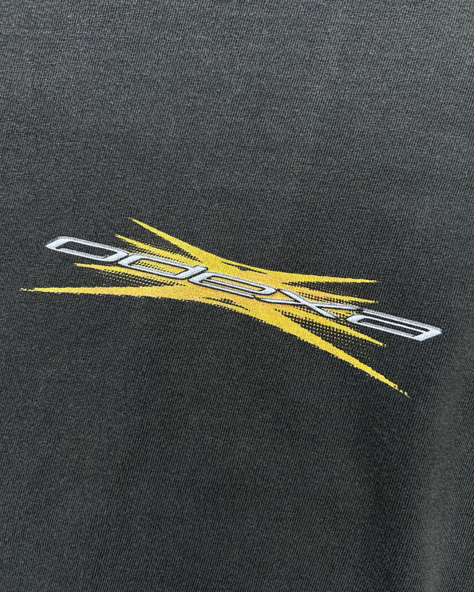 Close-up of yellow spark ODEXA logo print