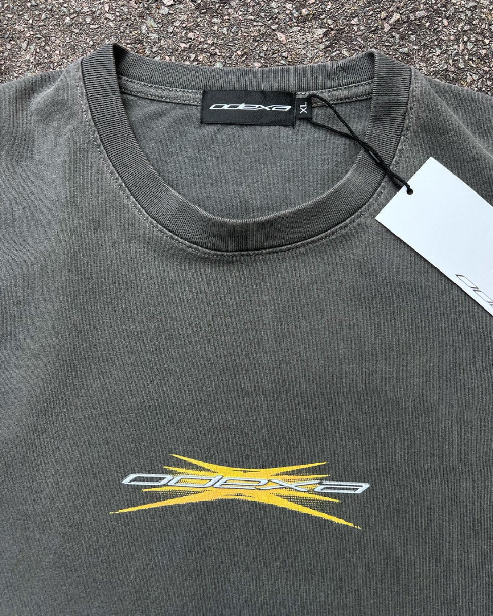 Washed black vintage tee with yellow spark ODEXA logo, flat lay